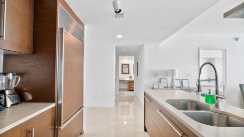 a kitchen with a sink and a stainless steel refrigerator at Icon Brickell 1 bed Miami 32nd in Miami