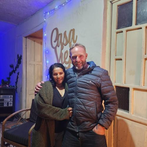 a man and a woman standing in front of a sign at CASA VIEJA del Centro Historico in Quito