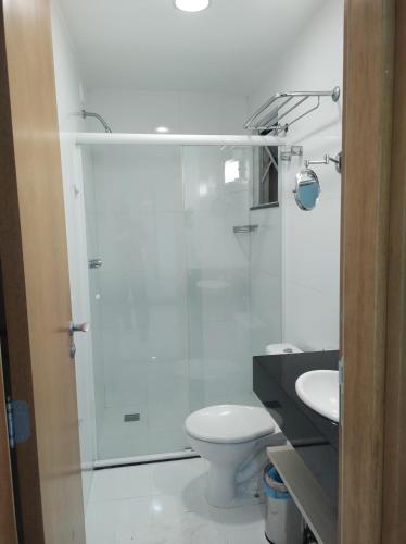 a bathroom with a shower and a toilet and a sink at Porto Marina Mont Blanc Resort II in Mangaratiba
