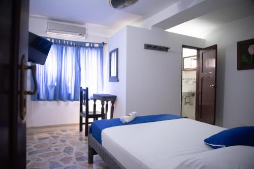 Postel nebo postele na pokoji v ubytování Hotel Acapulco Caucasia