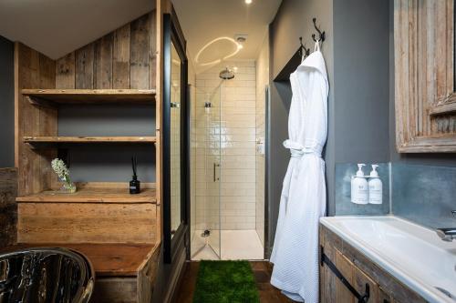 a bathroom with a shower and a sink and a shower at The Cocktail Lounge at Cheshire Boutique Bathhouse in Nantwich