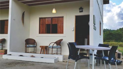 a table and chairs in front of a house at Flat completo do Rodeadouro in Bonito