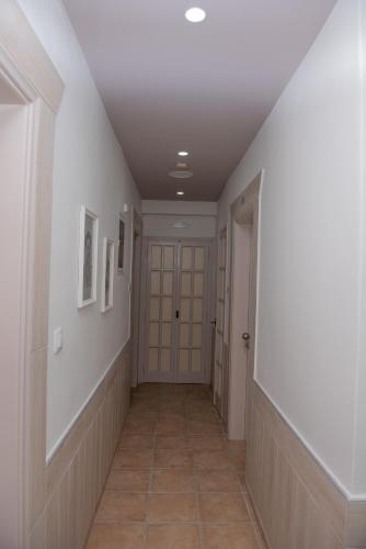a hallway with a door and a tile floor at Tsaner Apartment and Rooms in Matala