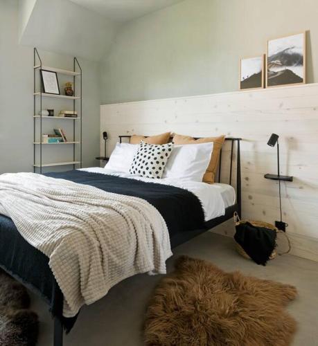 a bedroom with a large bed with a brown rug at Apartament Czerwona Łasica in Jaworki