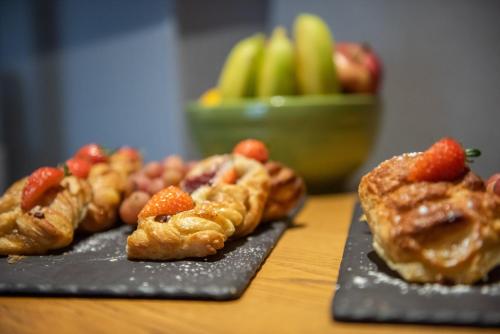 two plates of pastries and fruit on a table at Holiday Inn Preston by IHG in Preston