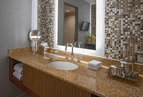 a bathroom with a sink and a mirror at Hyatt Regency Denver Tech Center in Denver
