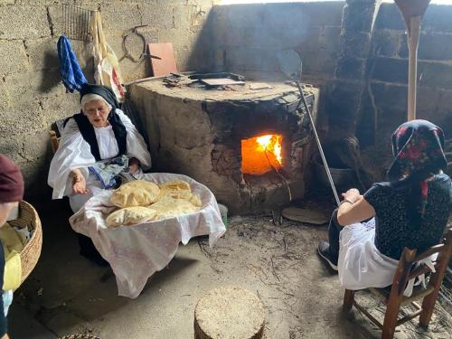 two women are sitting in front of an oven at Casa vacanze “Dolce sosta” in Quartu SantʼElena