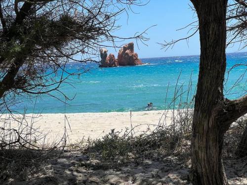 a beach with two large rocks in the water at Casa vacanze “Dolce sosta” in Quartu SantʼElena