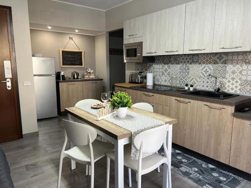 a kitchen with a table and chairs and a kitchen with a refrigerator at Casa vacanze “Dolce sosta” in Quartu SantʼElena