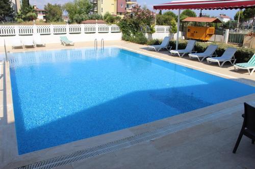 a large swimming pool with blue water in a building at Side Alya Hotel in Side