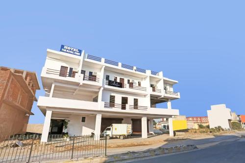 a white building on the side of a street at The Royal Fern in Farrukhnagar