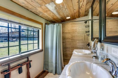 a bathroom with two sinks and a window at Idyllic Wishon Vacation Rental about 9 Mi to Bass Lake in Bass Lake Annex
