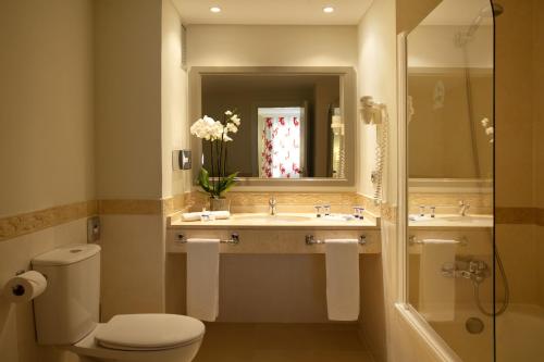 a bathroom with a toilet and a sink and a shower at Ona Marinas de Nerja Spa Resort in Nerja