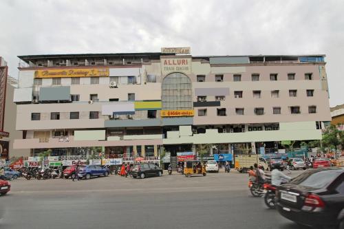 a large white building with cars parked in front of it at Sahasra Residency 43619 Near Nexus Hyderabad in Hyderabad