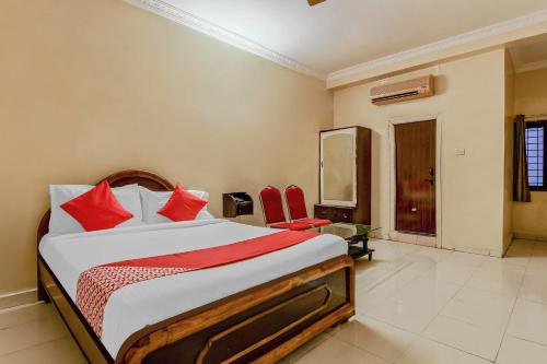 a bedroom with a large bed with red pillows at Sahasra Residency 43619 Near Nexus Hyderabad in Hyderabad
