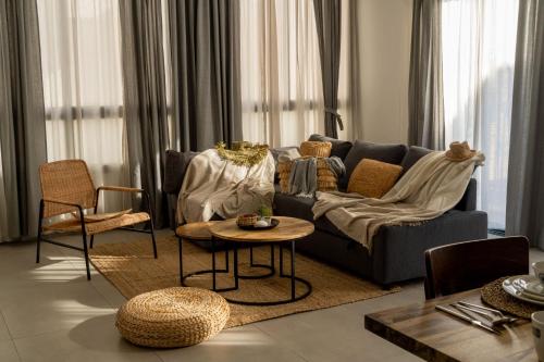 a living room with a couch and a table and chairs at HaKerem new luxury 3 rooms apartments and 2 rooms penthaus in Tel Aviv