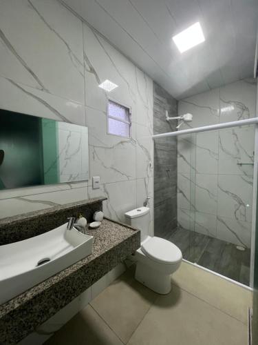 a bathroom with a toilet and a sink and a shower at Pousada do Nativo in Fernando de Noronha