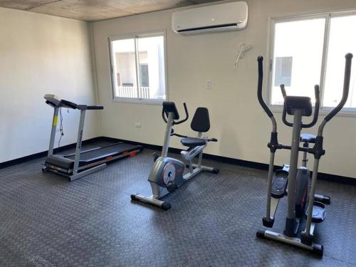 a gym with several exercise bikes in a room at Belleza nueva! Zona Conmebol (606) in La Mercedes