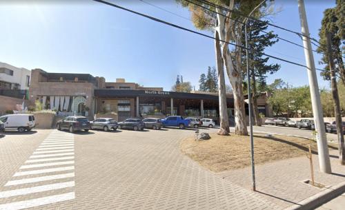 a street with cars parked in a parking lot at HOUM alojamientos, NORTH GREEN in Villa Allende