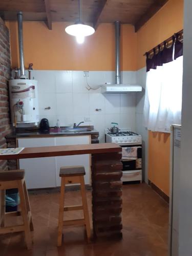 a kitchen with a counter and a stove at Departamentos alvear in Esquel