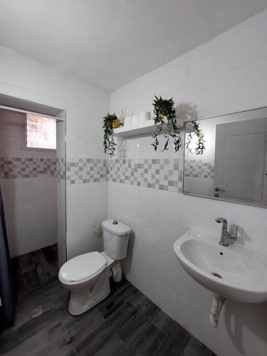 a bathroom with a toilet and a sink at Уютная 2-х комнатная квартира недалеко от моря in Ashdod