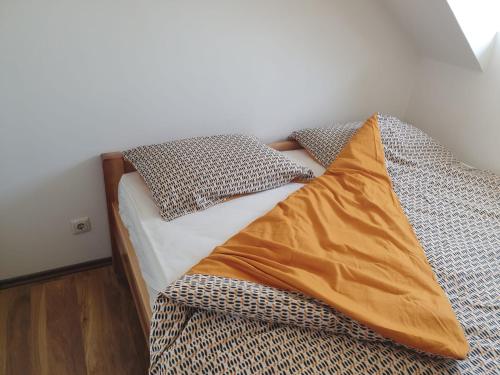a bed with two pillows on it in a room at Apartman Benedikta in Zagreb