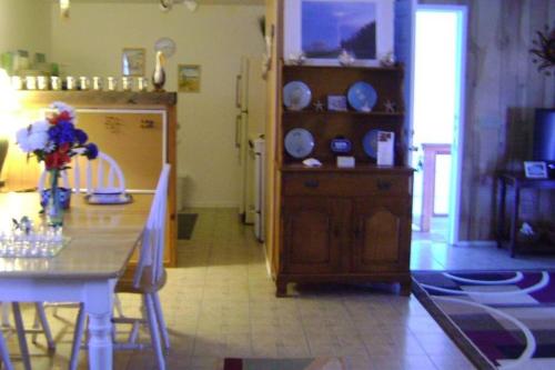 a kitchen with a table and a dining room at Suite Breeze Beach Vacation Rental - one bedroom apartment. in Morro Bay