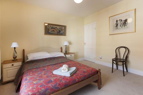 a bedroom with a bed with a towel on it at Highfield Grove in Nottingham