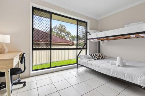 a bedroom with two bunk beds and a desk at Large seven bed house in Jesmond