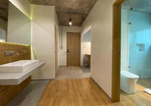 a bathroom with a sink and a toilet at The Host Business Suites at WTC in Mexico City