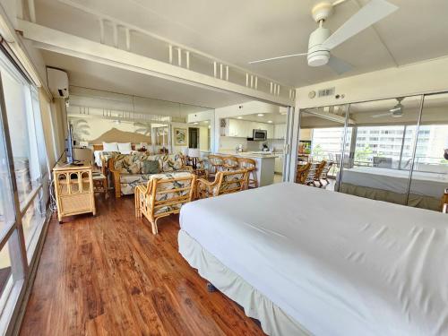 a bedroom with a large bed and a dining room at Ilikai Tower 633 Yacht Harbor View 1BR in Honolulu