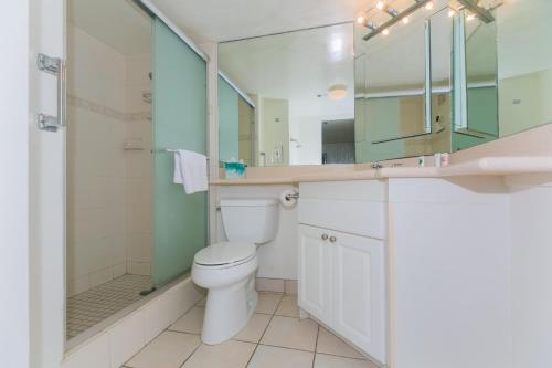 a bathroom with a toilet and a shower and a sink at Ilikai Tower 633 Yacht Harbor View 1BR in Honolulu