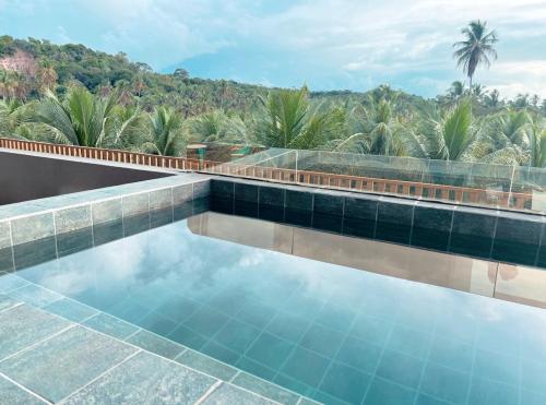 a swimming pool with a view of a resort at Milagres Hospedagens - Praia e Vista Coqueiros in São Miguel dos Milagres