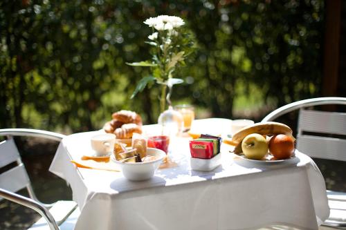 a white table with food on top of it at Anusca Palace Hotel in Castel San Pietro Terme