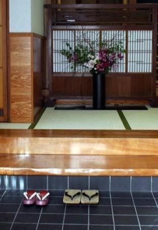 two pairs of shoes sitting on the floor of a room at Kikunoya Ryokan in Kanazawa
