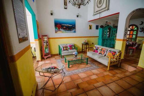 a living room with two couches and a table at Casa Oaxaqueña in Santa Cruz Huatulco