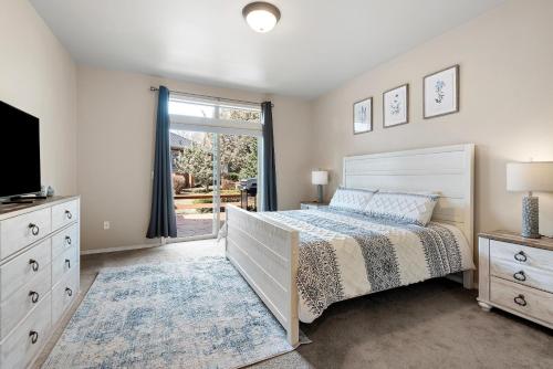 a bedroom with a bed and a tv and a window at HomeAway Vacation Rental - Eagle Crest - Meredith Lodging in Redmond
