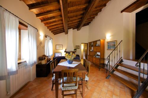 a living room with a table and chairs and a couch at Podere Varlunga in Borgo alla Collina