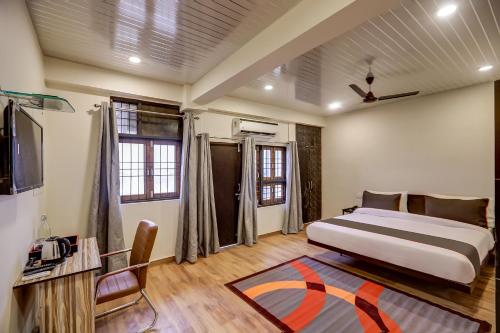 a bedroom with a bed and a tv in it at Collection O Sr Inn Awas Vikas in Kānpur