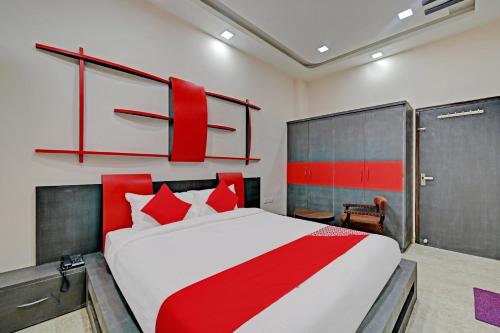 a bedroom with a large bed with red pillows at OYO The Castle Home Stay Inn in Jaipur