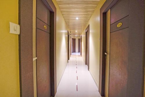 a hallway with two doors and a long corridor at Hotel Sapna Near Anand Nagar (Dahisar) Metro Station in Mire
