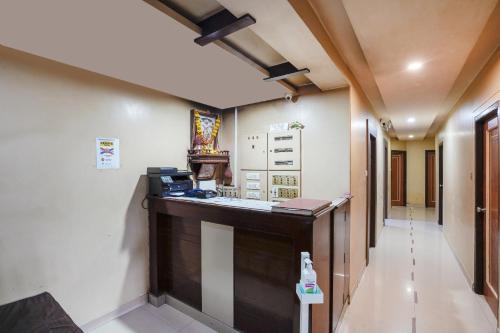 a corridor of a hospital with a reception desk at Hotel Sapna Near Anand Nagar (Dahisar) Metro Station in Mire