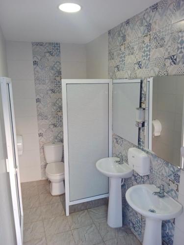 a bathroom with two sinks and a toilet at Mar de Indias House in Cartagena de Indias