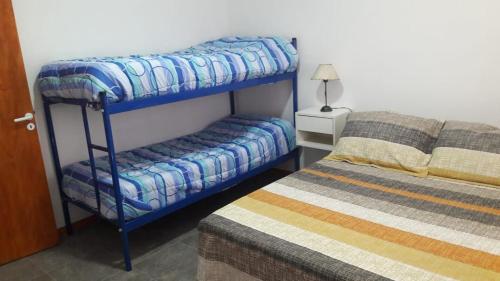 a bedroom with two bunk beds and a bed at Antú in Carhué