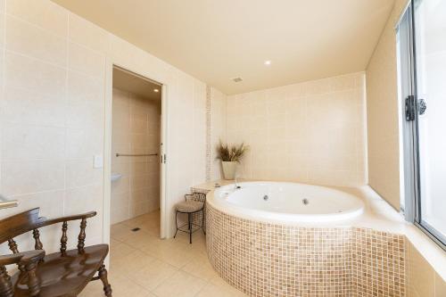 a bathroom with a bath tub in a room at The Crest Penthouse 902 in Forster