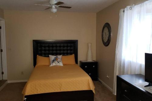 a bedroom with a bed and a ceiling fan at "Mentor Place" a 4 bedroom home in the heart of a lake community min away from lot's activities in Mentor