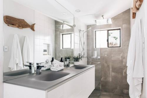 a bathroom with two sinks and a shower at Entertainment Haven 900m to the Beach in Kawana Waters