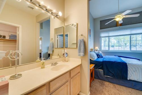 a bathroom with a sink and a bed and a mirror at Cozy Arizona Retreat with Patio, Grill and Pool Access in Mesa