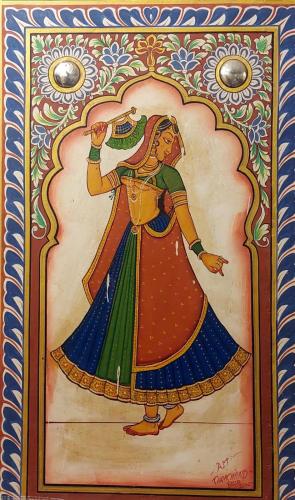 a painting of a woman with a bird on her head at Hotel Shekhawati Haveli in Mandāwa