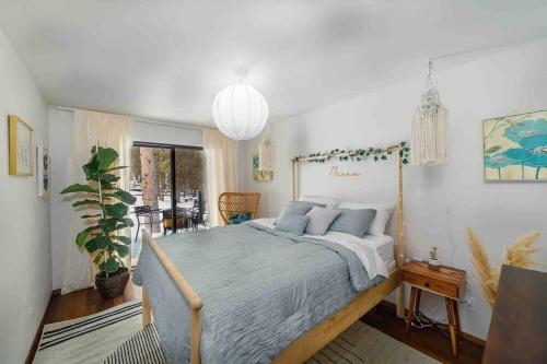 a bedroom with a large bed with blue pillows at Awesome family vacation home in Bragg Creek in Bragg Creek